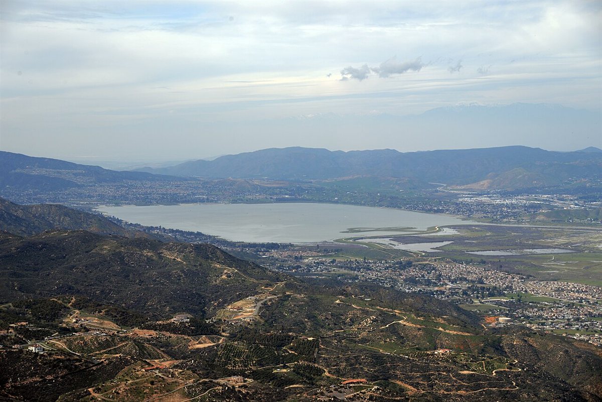 Aerial view of Lake Elsinore, the largest natural freshwater lake in Southern California, surrounded by mountains and neighborhoods